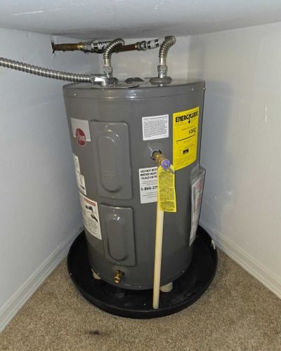 Water Heater In Corner With Pipes And Safety Labels Tampa Fl