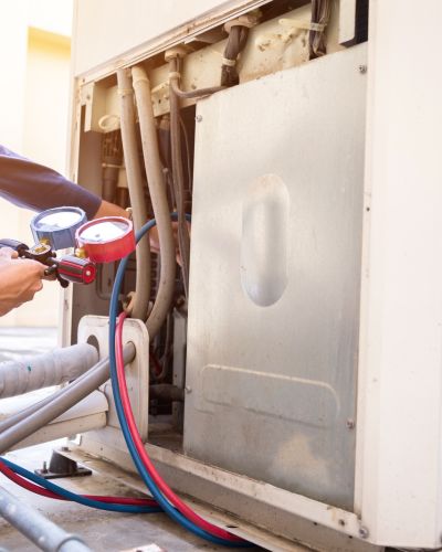 Air Conditioner Repair Technician Measuring Pressure Gauges