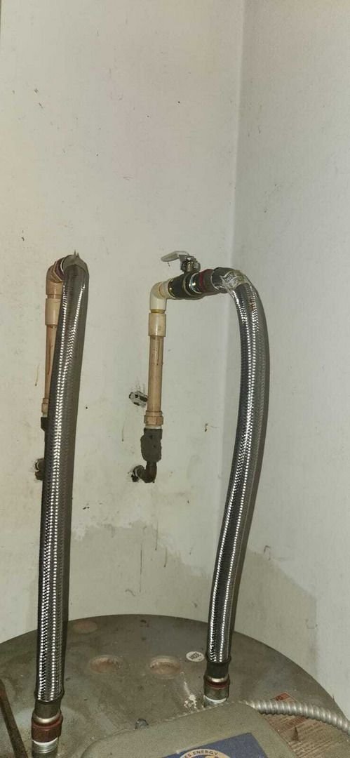 removal and installation of plumbing connections near a hot water heater with flexible piping and shut off valves present