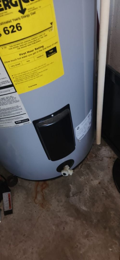 water heater installation with energy efficiency label visible pipes and controls are arranged nearby