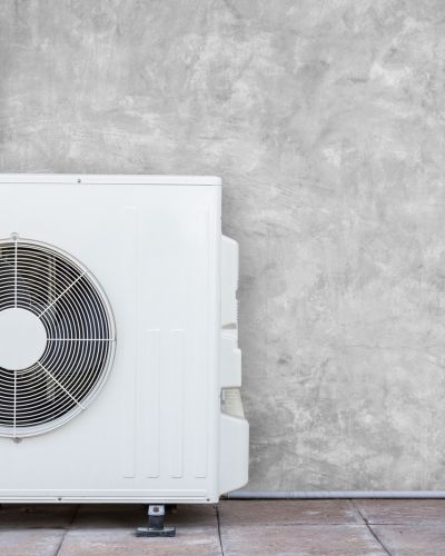 Outdoor Air Conditioner Unit On Wall With Gray Background Tampa Fl