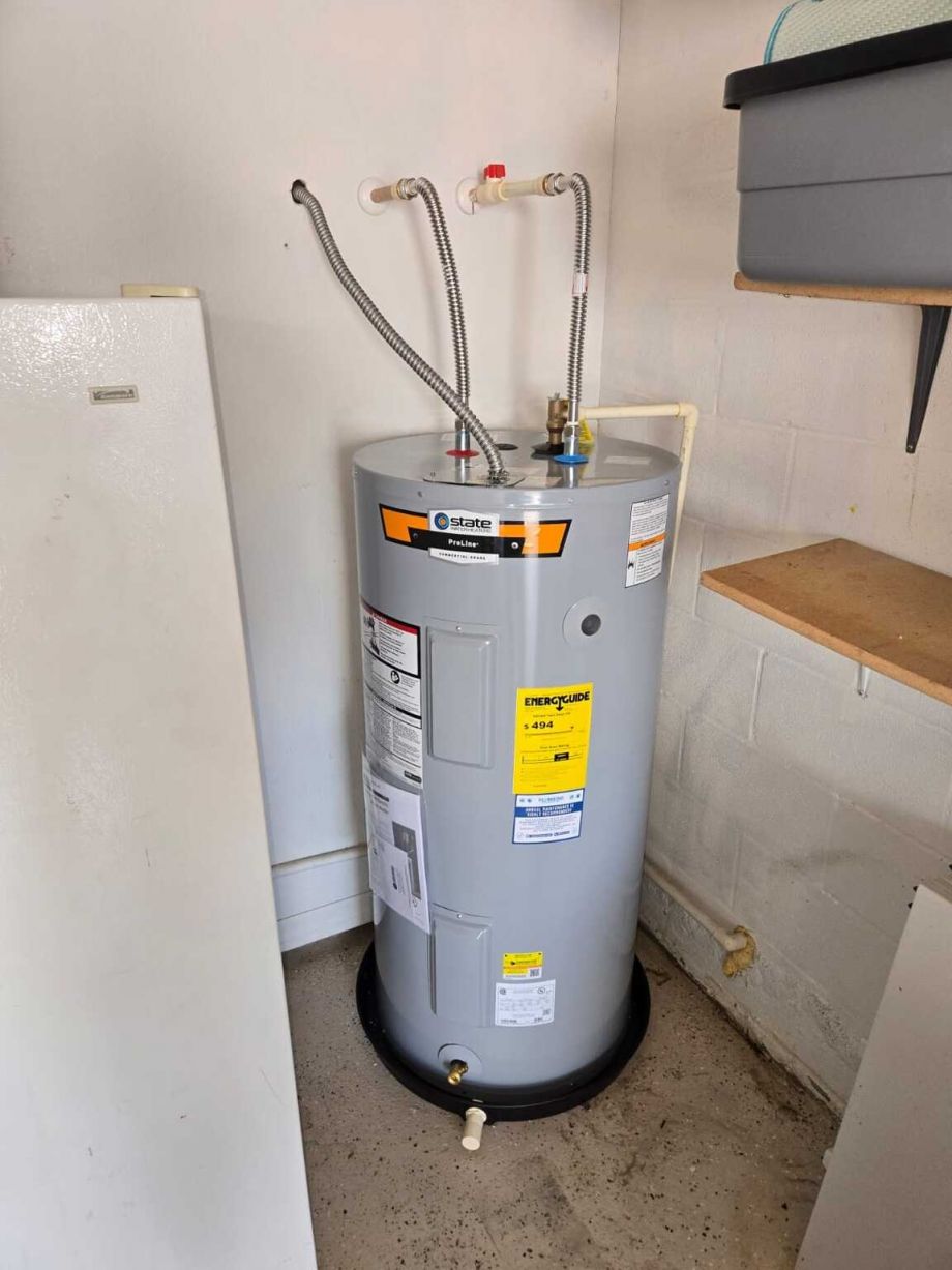 Water Heater In Utility Room With Connected Pipes And Valves