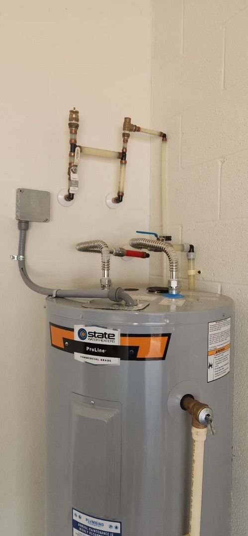 plumbing service involving installation or maintenance of a state proline commercial grade water heater with connected pipes and valves