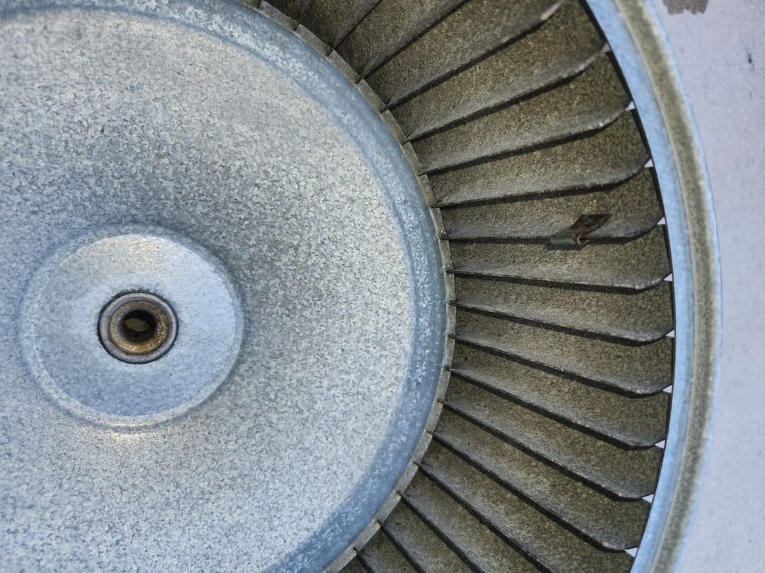 Metal Fan With Visible Dust And Debris Buildup Indicating A Need For Cleaning Or Maintenance Service