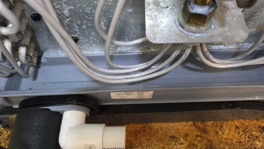 pipes and wires are visible likely related to heating or cooling system installation or maintenance activities