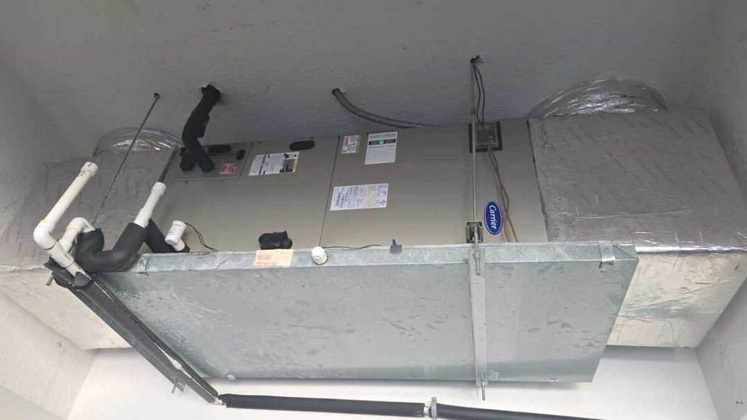 home therapist cooling heating and plumbing installing or servicing an hvac unit with ductwork and insulation visible