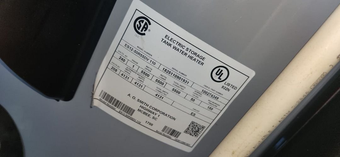 electric storage tank water heater manufacturer label with specifications and model information visible on the exterior of the tank