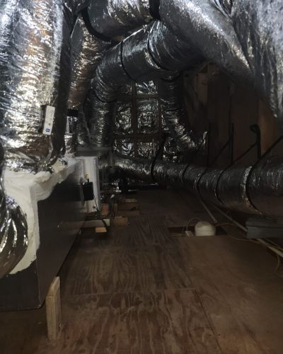 Ductwork In Attic With Insulated Pipes And Wooden Floor Tampa Fl
