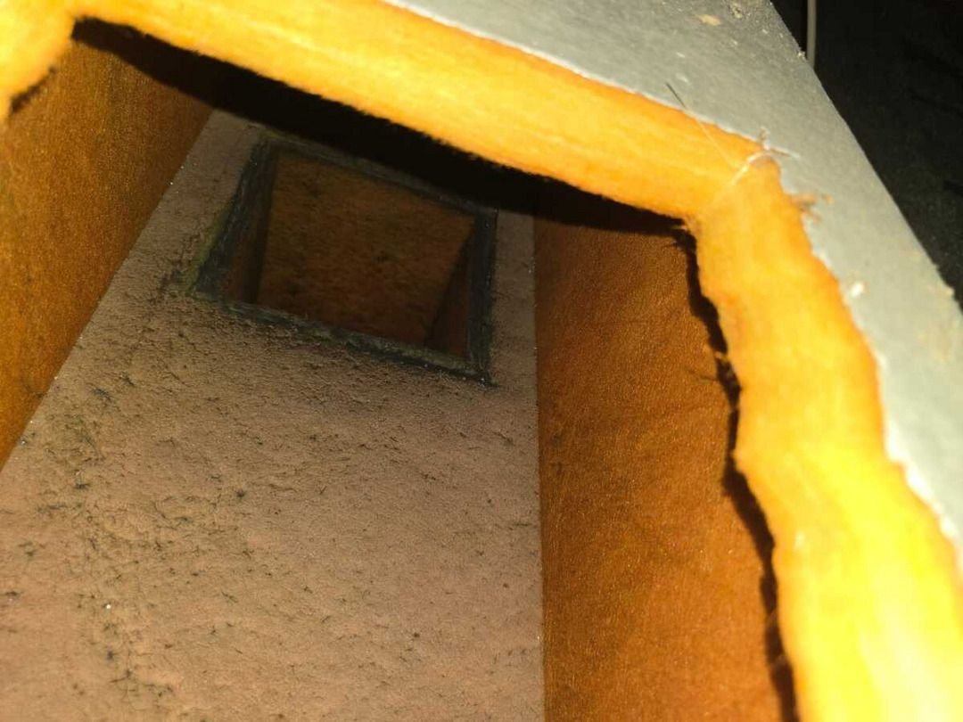 ductwork inspection showing accumulations of dust and debris inside a rectangular duct system