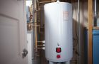 Hot Water Tank In Utility Room With Pipes And Valves