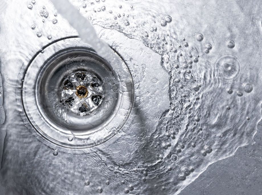 Flowing Water Draining Into Sink Drain With Bubbles