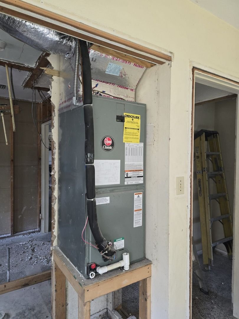 home therapist cooling heating and plumbing installing a new furnace in a partially renovated area with visible tools and materials