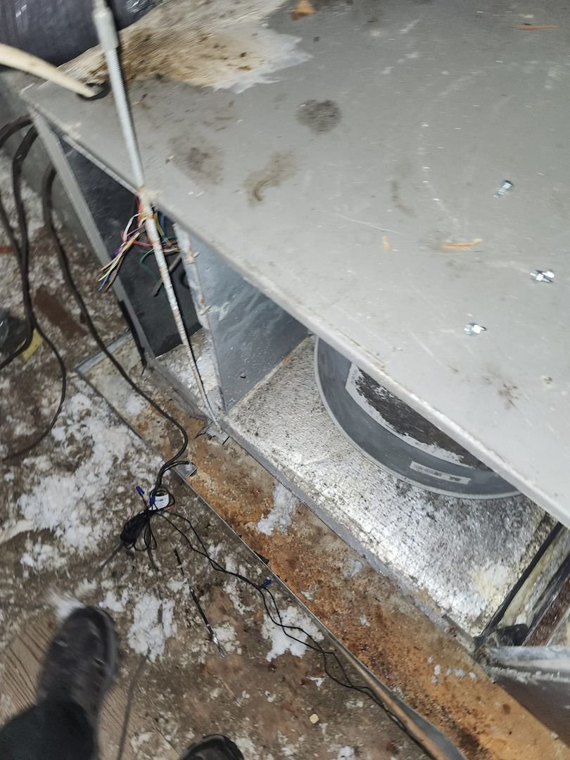 Air Duct Inspection Showing Dust Debris And Wiring In A Mechanical Space Near Ductwork And A Visible Fan System