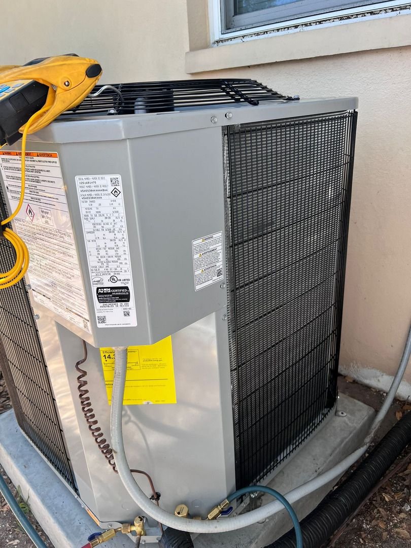 Home Therapist Cooling Heating And Plumbing Servicing An Outdoor Air Conditioning Unit With Gauges And Tools Nearby