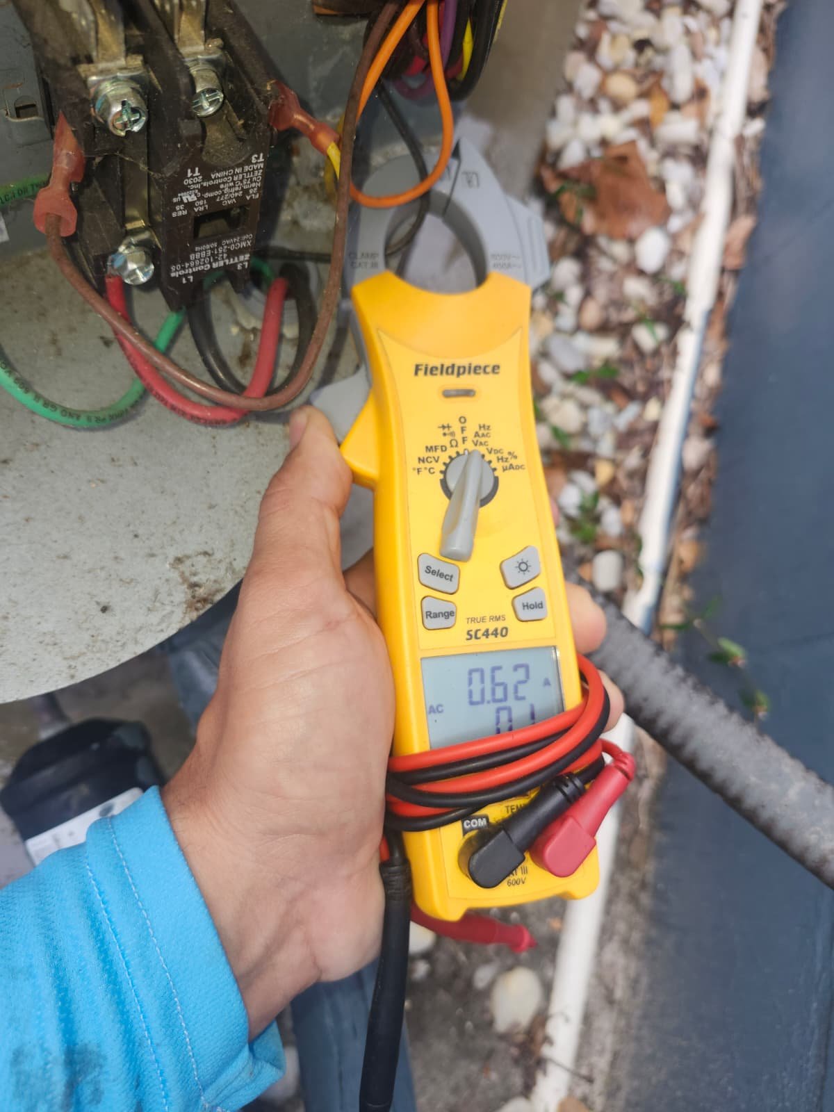 Technician verifying AC capacitor values during Lutz, FL 33549 maintenance