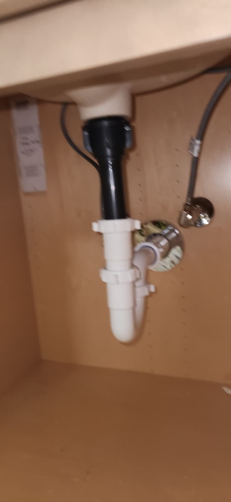 Close-up of new p-trap connection to sink drain line in Lutz, FL 33559