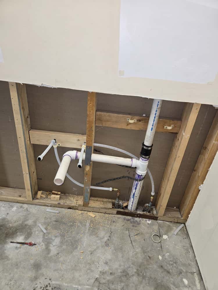 Close-up of PVC sewer and water line connections in Lutz, FL 33559