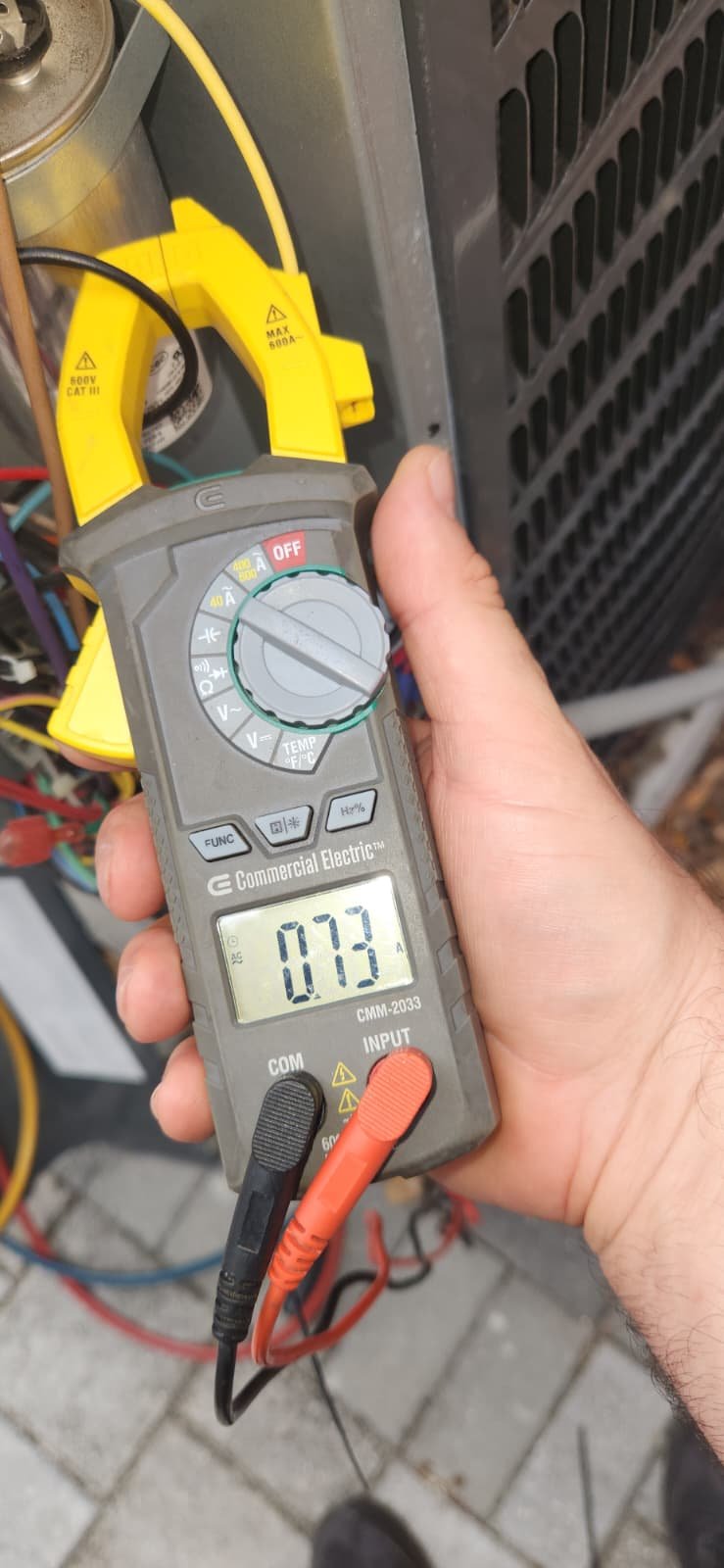 Technician checking reversing valve operation after solenoid replacement in Tampa FL 33612