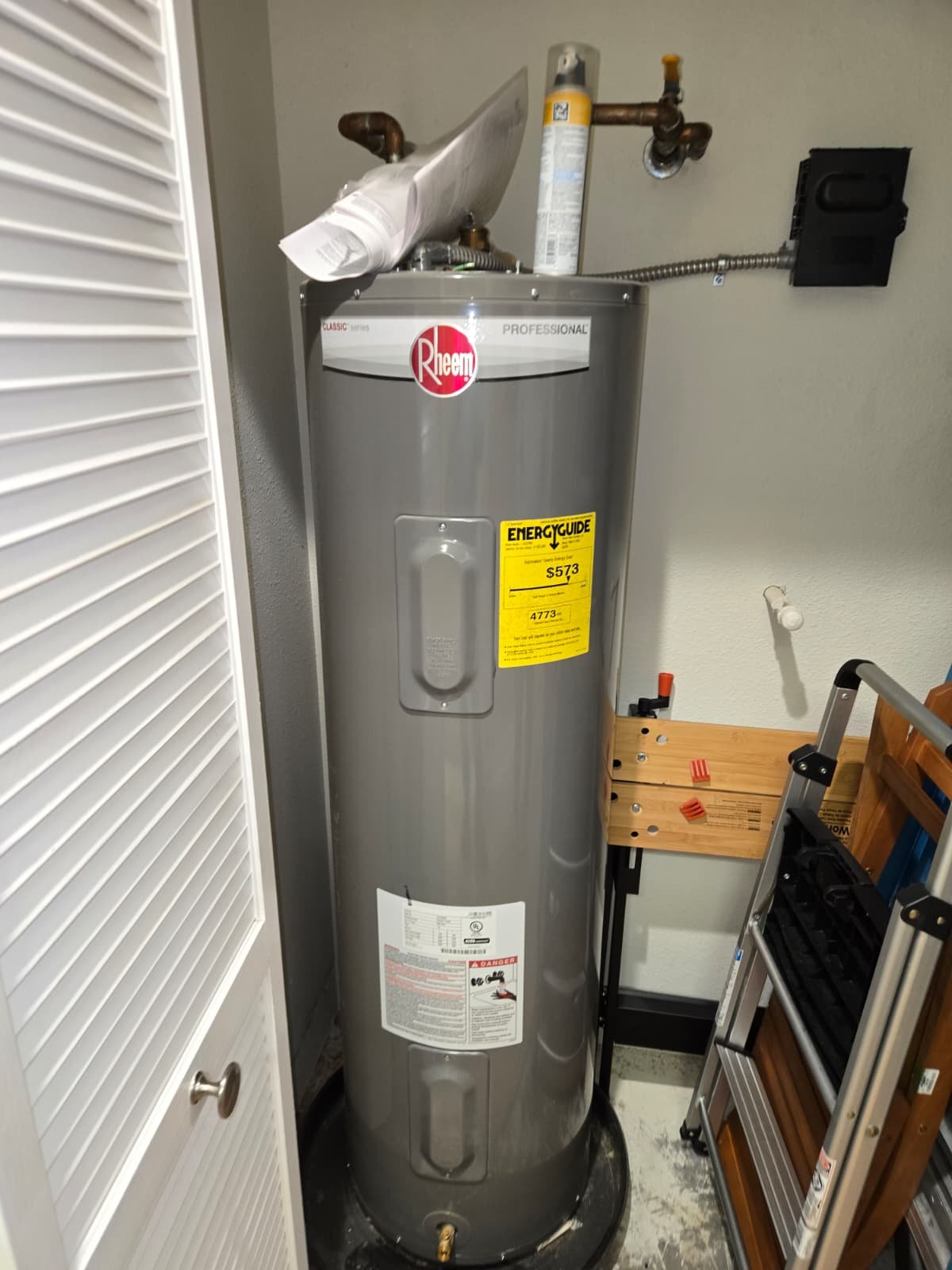 New Rheem tall electric water heater replacement in Dunedin, FL 34698 garage