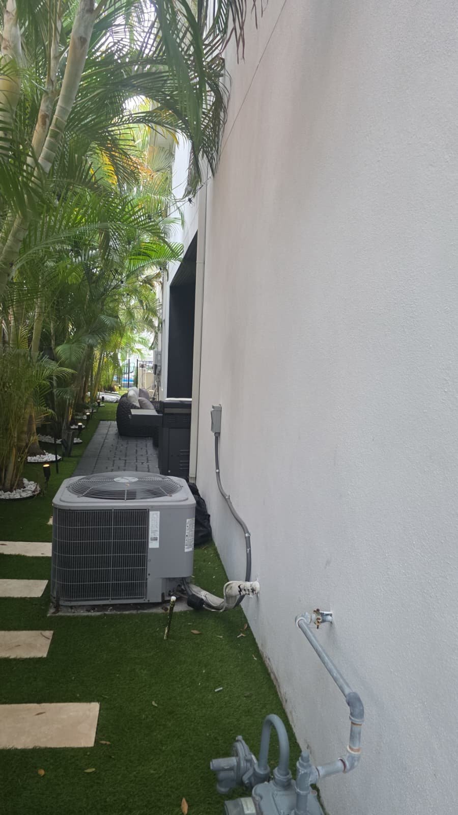 Wall bracket installation for relocated condenser unit in Tampa, FL 33606