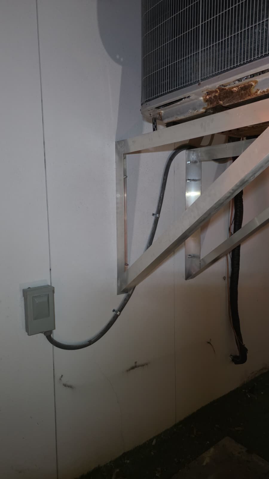 AC tune-up and condenser relocation completed on wall bracket in Tampa, FL 33606