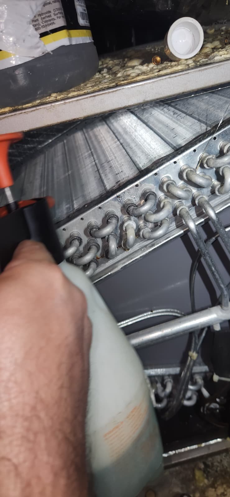 Technician checking refrigerant levels on AC system in Tampa, FL 33634