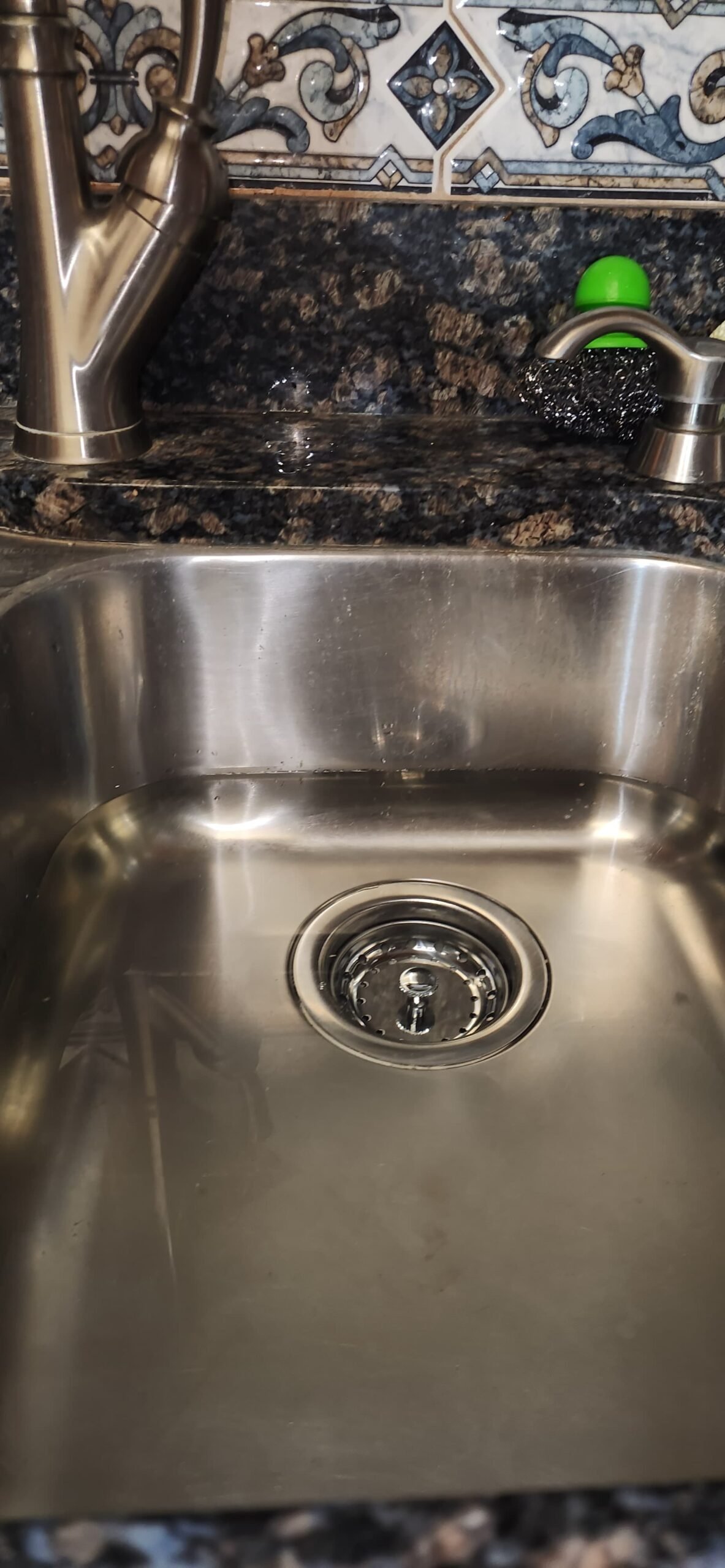 Under-sink plumbing after kitchen drain strainer replacement in Tampa, FL 33618