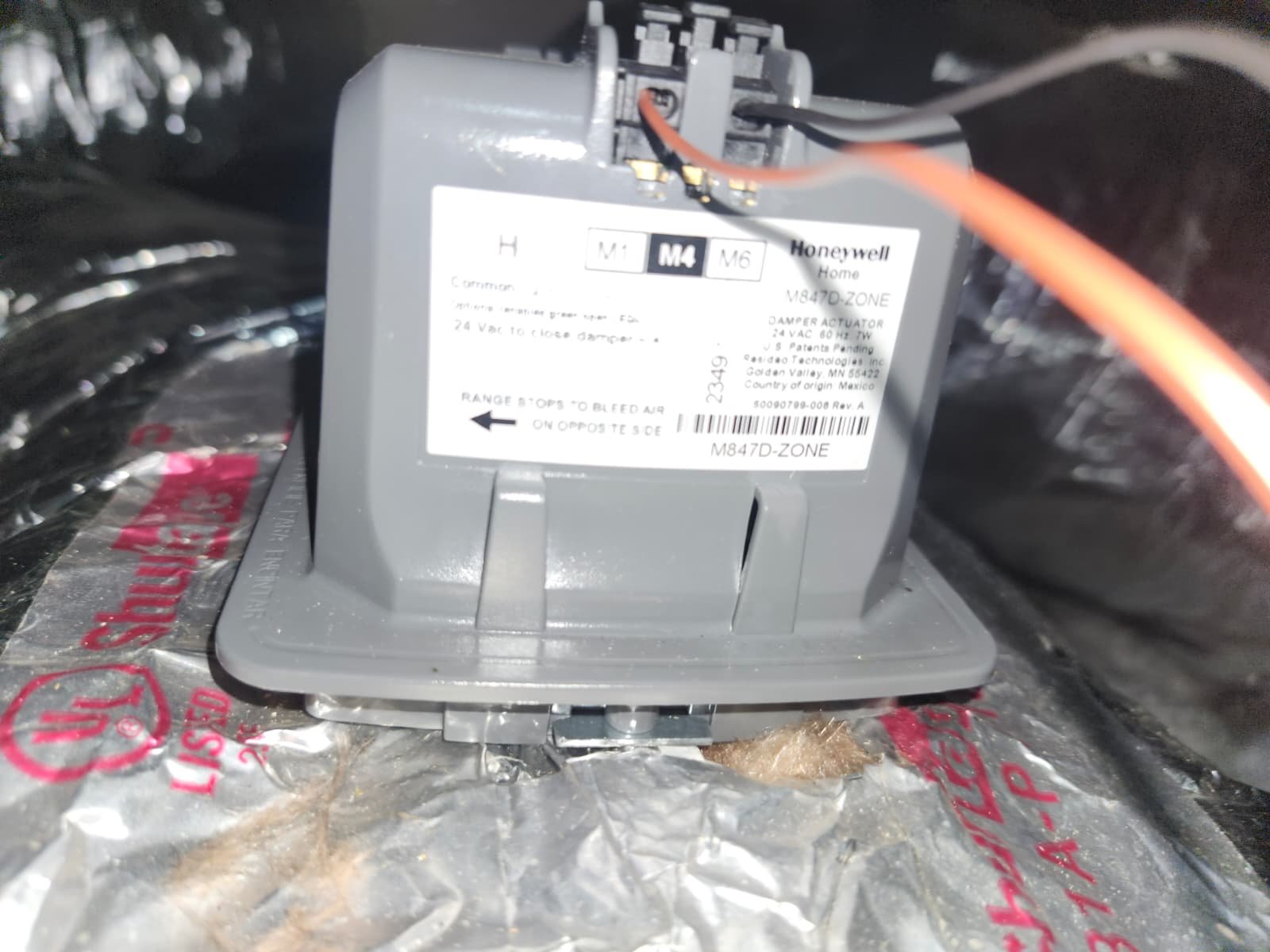 Technician adjusting Honeywell zone damper motor wiring in Lutz, FL 33559