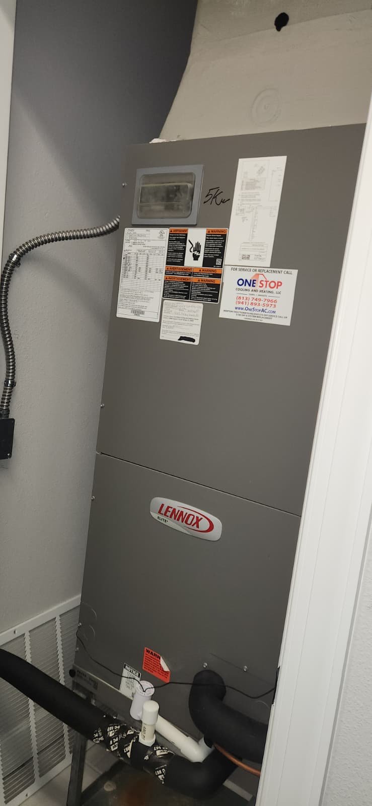 Preventative AC maintenance in Tampa, FL 33634 inspecting condenser fan