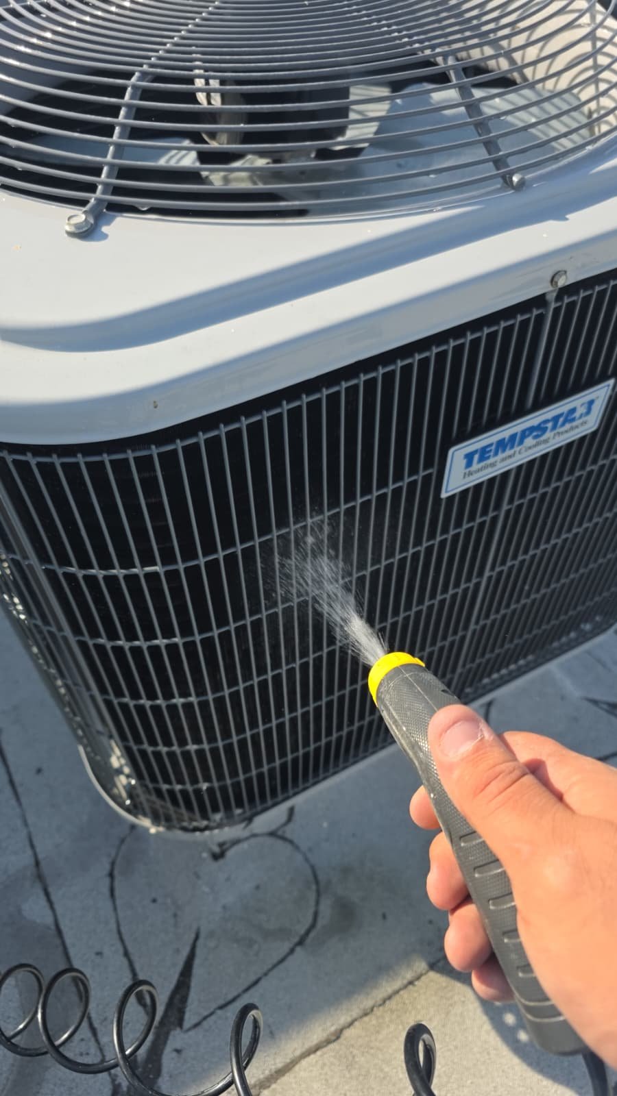 Technician checking AC refrigerant levels in Tampa, FL 33605 home