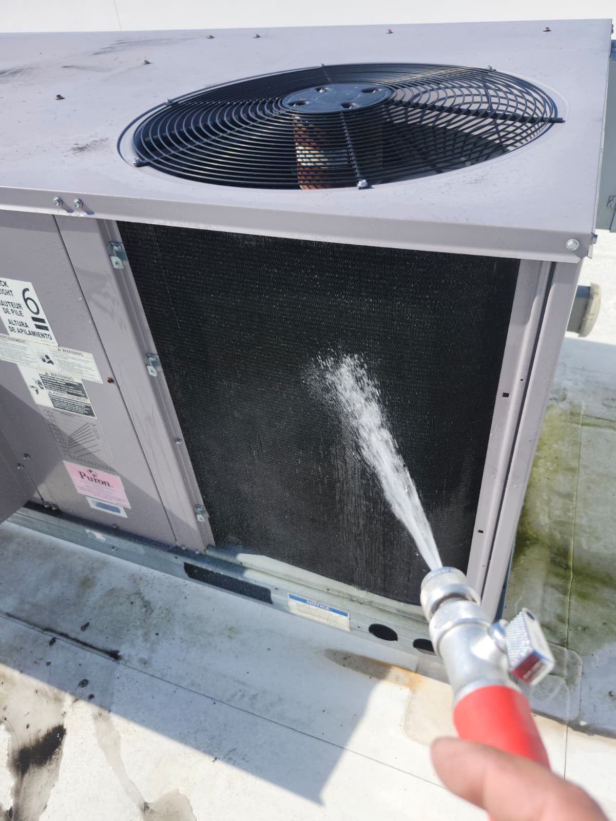 Quarterly HVAC maintenance on rooftop unit in Tampa, FL 33626