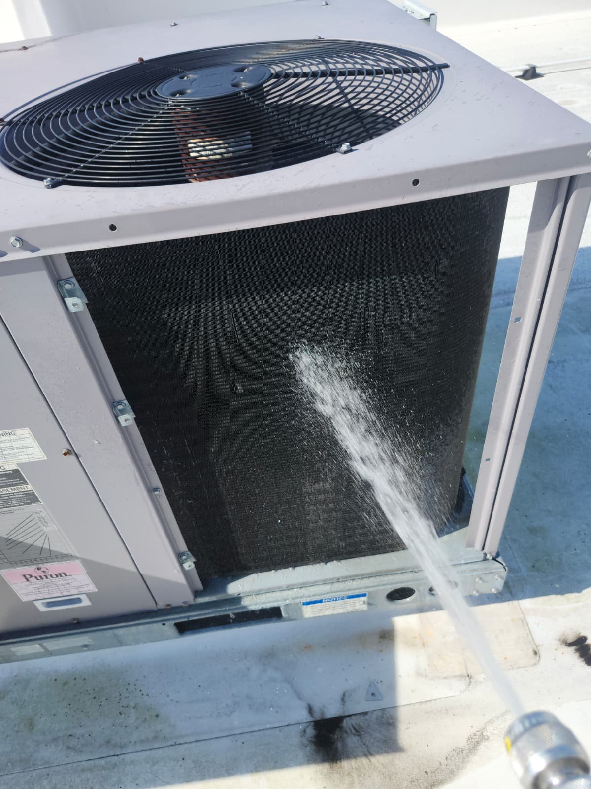 Filter change during rooftop HVAC service in Tampa, FL 33626