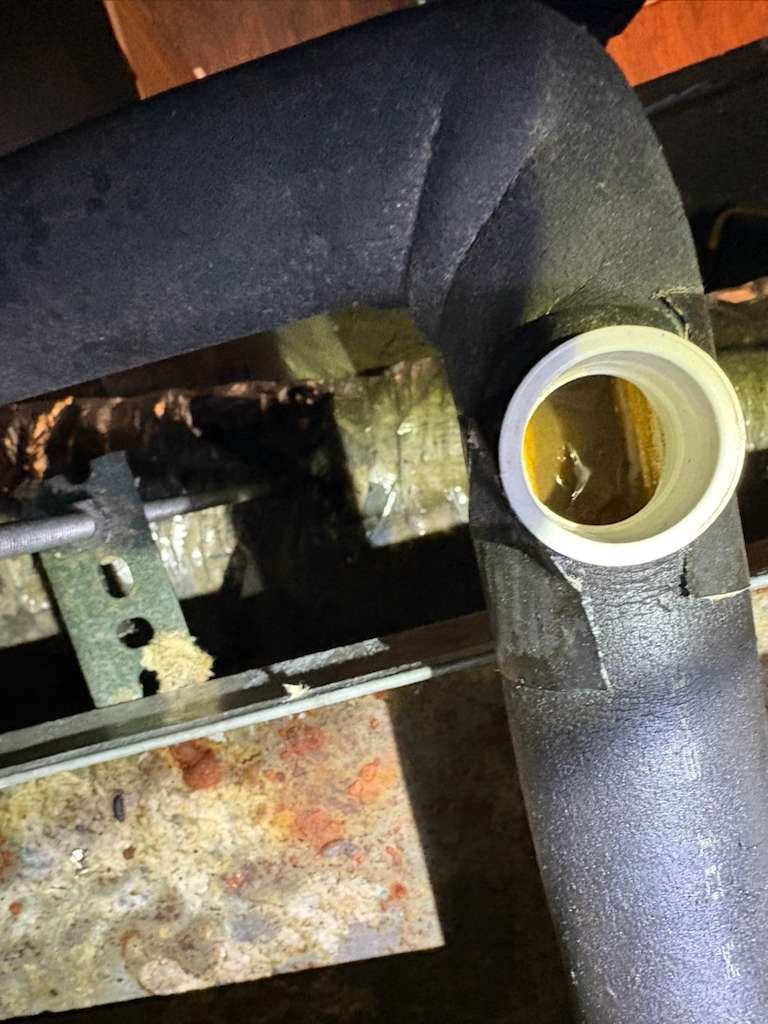 Technician securing conduit and whip for AC disconnect in St. Petersburg FL 33712