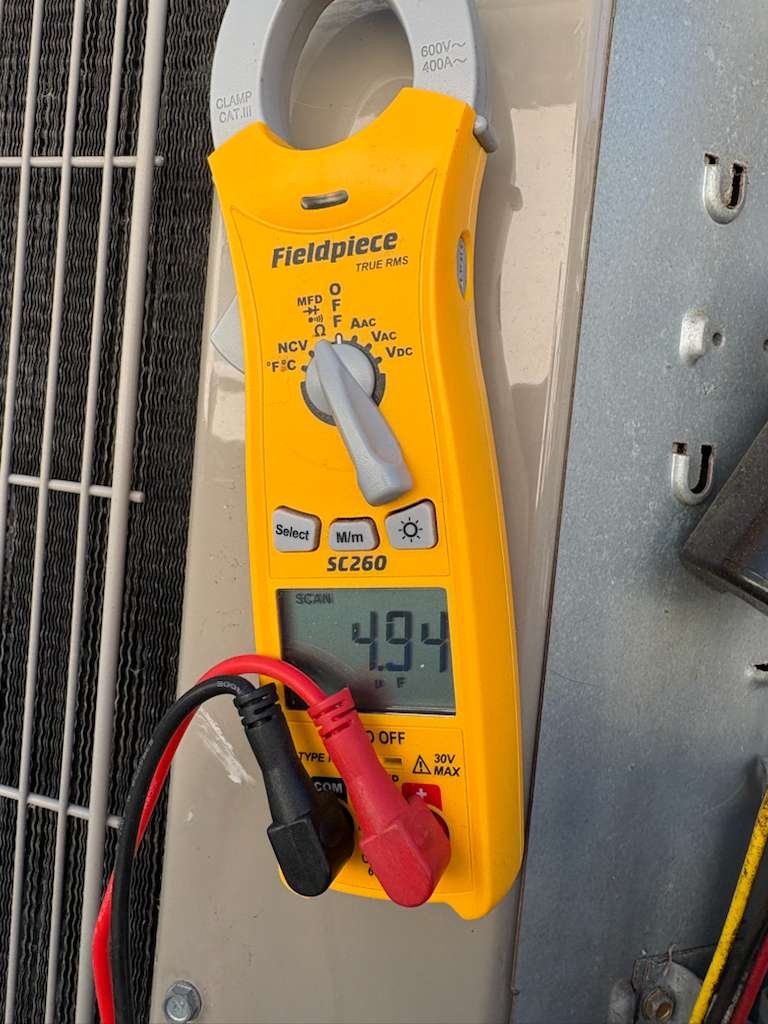 Technician performing AC tune-up in Tampa, FL 33616