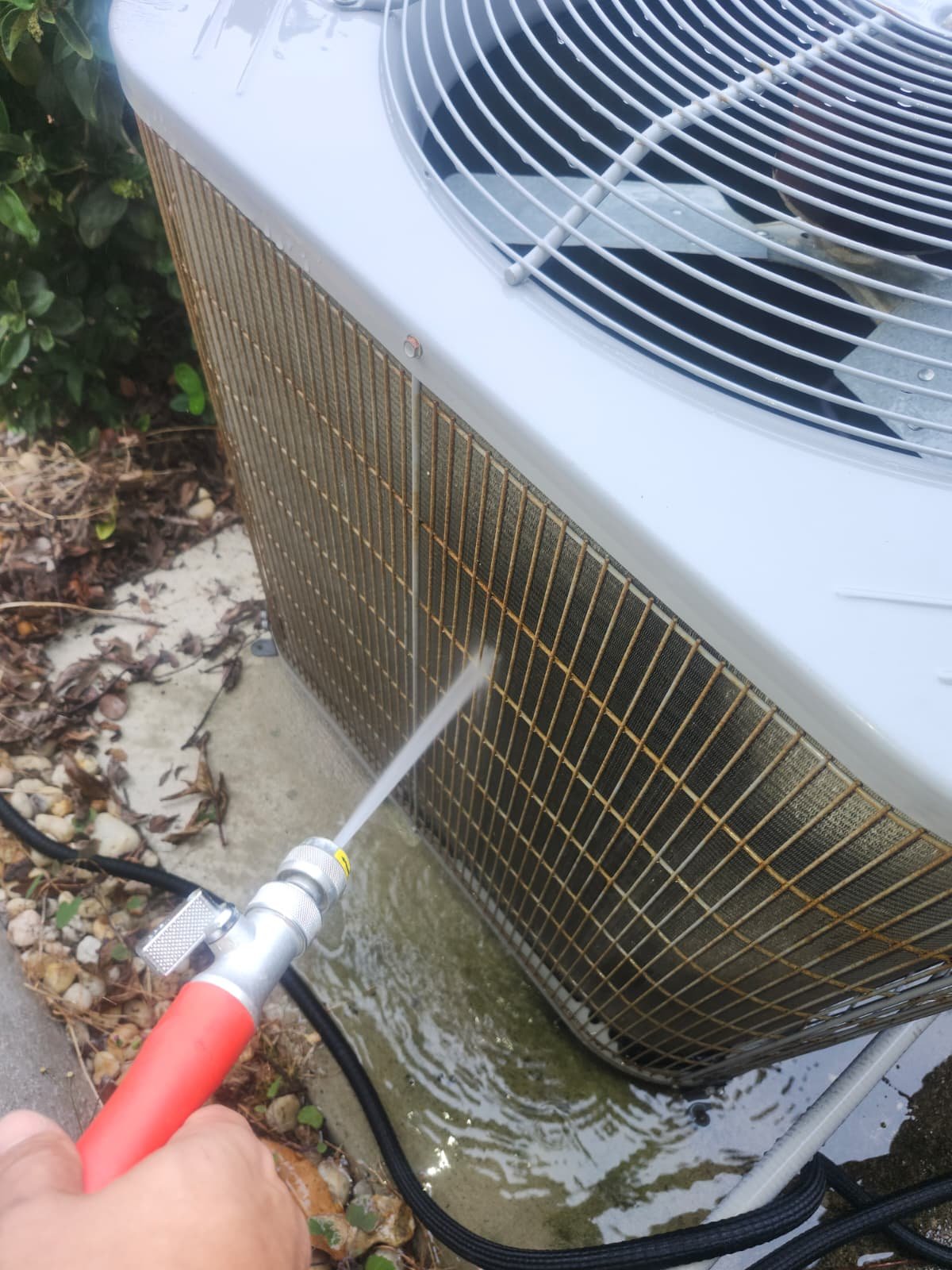 AC maintenance technician checking electrical components in Spring Hill, FL 34610