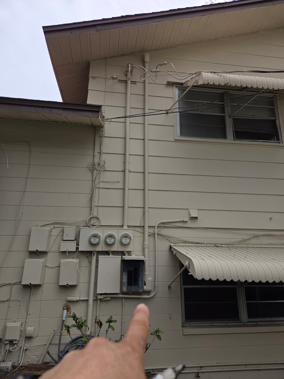 Completed Rheem water heater installation with drain pan in Lakeland, FL 33801 utility area