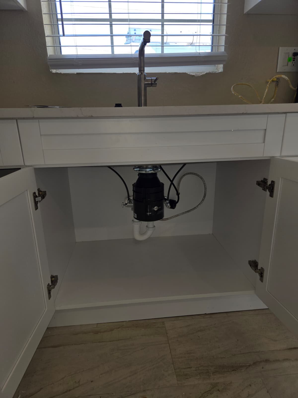 Plumbing connections checked after garbage disposal installation in St. Petersburg, FL 33703