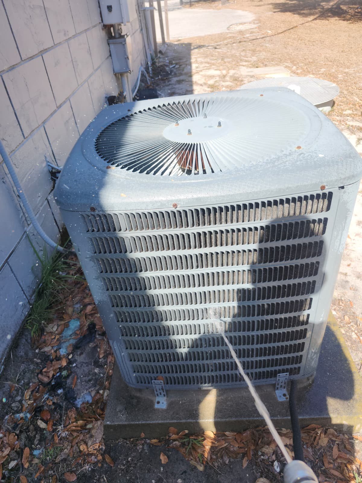 Technician performing HVAC maintenance on Goodman unit in Hudson, FL 34669