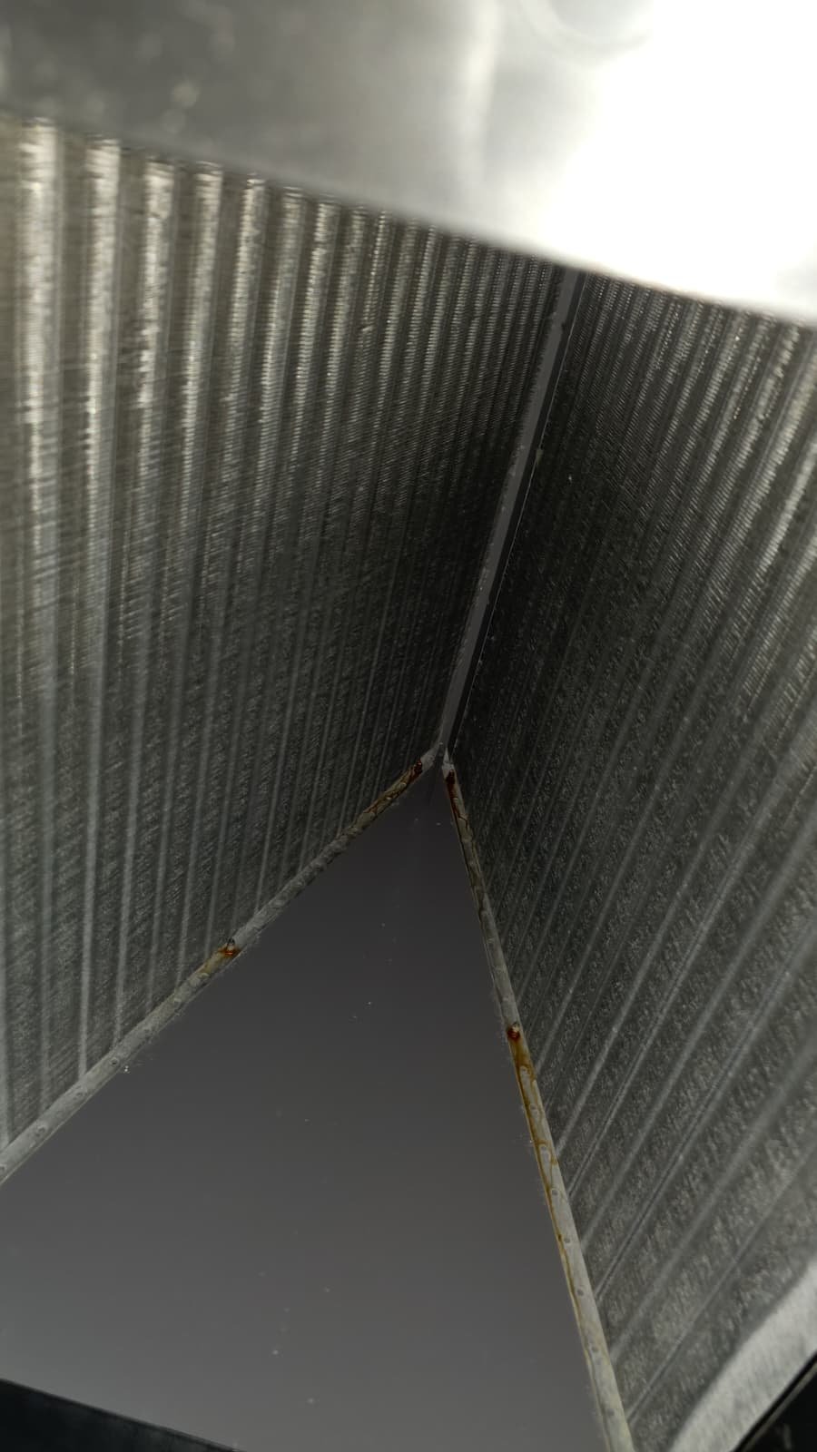 Riverview FL technician checking blower motor amperage during AC tune-up