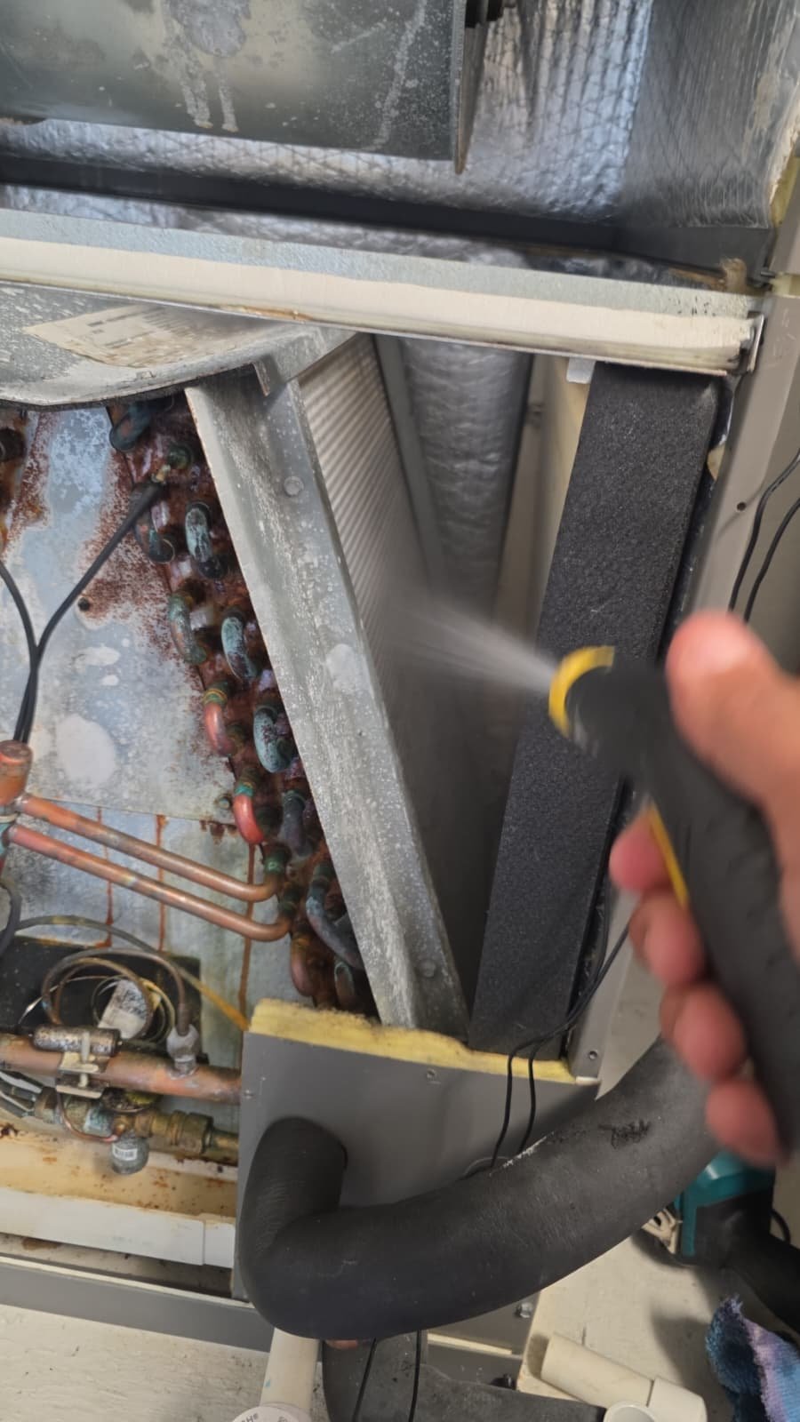 Indoor air handler cleaning during HVAC maintenance visit in Wimauma, FL 33598