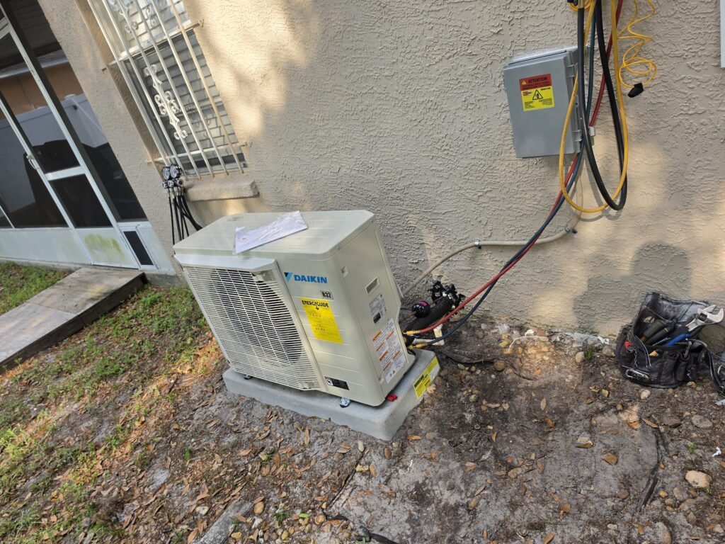 A Daikin mini-split outdoor unit on its pad in Tampa, FL 33624.