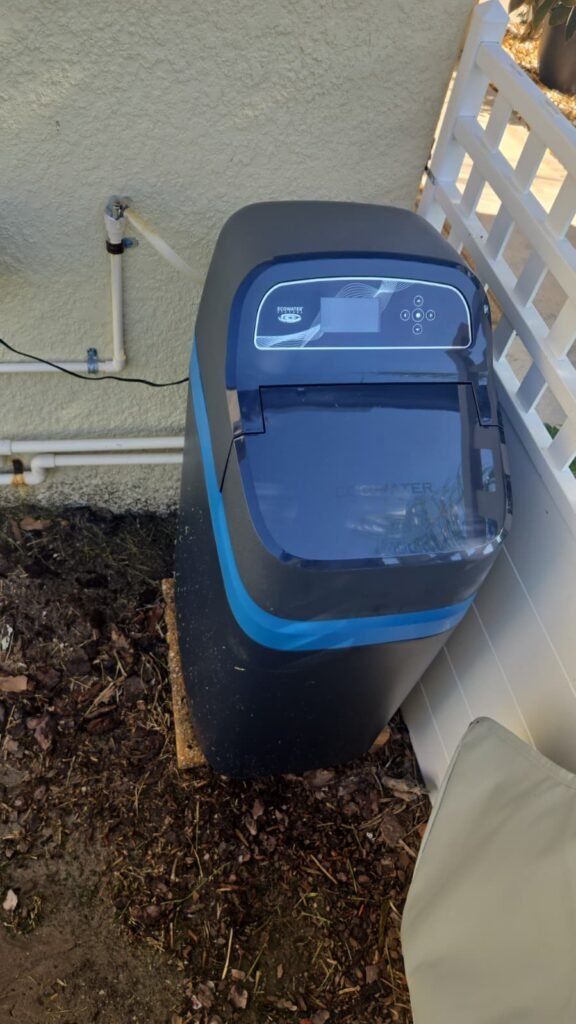 A cabinet water softener installed outside a home in Lutz, FL 33558.