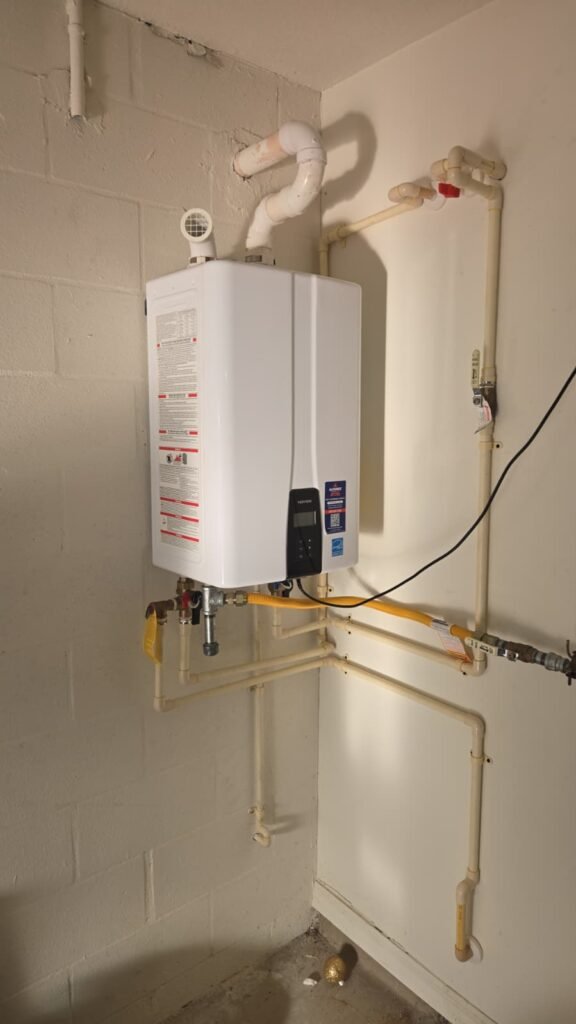 A wall-mounted tankless water heater with its piping in Tampa, FL 33624.