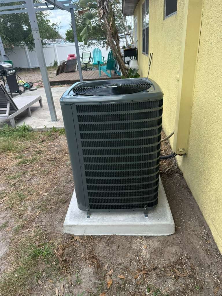 Newly installed 3 ton AC unit on concrete pad in Tampa, FL 33624. Efficient cooling solution.