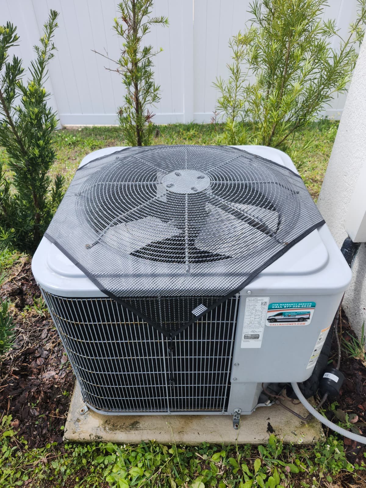 AC unit with protective cover installed after maintenance in Wimauma, FL 33598.
