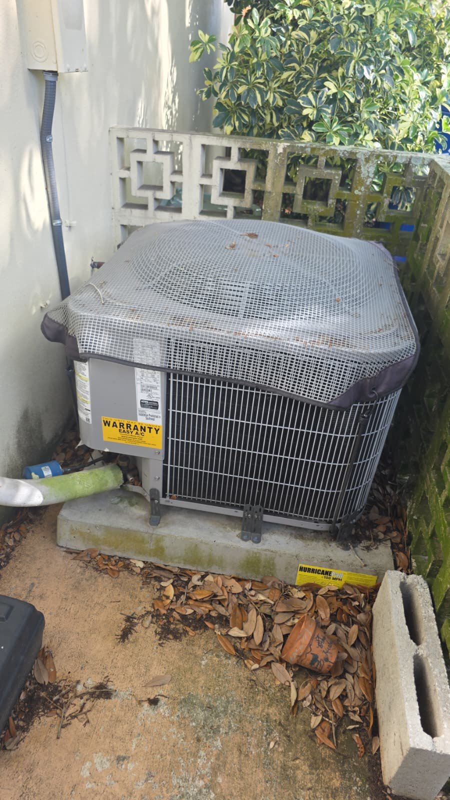 Clean outdoor AC unit with warranty sticker, part of Premium Therapy Plan in Palm Harbor, FL 34683.