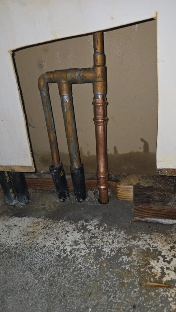 A new copper section with press fittings joined into the old supply lines through a wall opening in Tampa, FL.