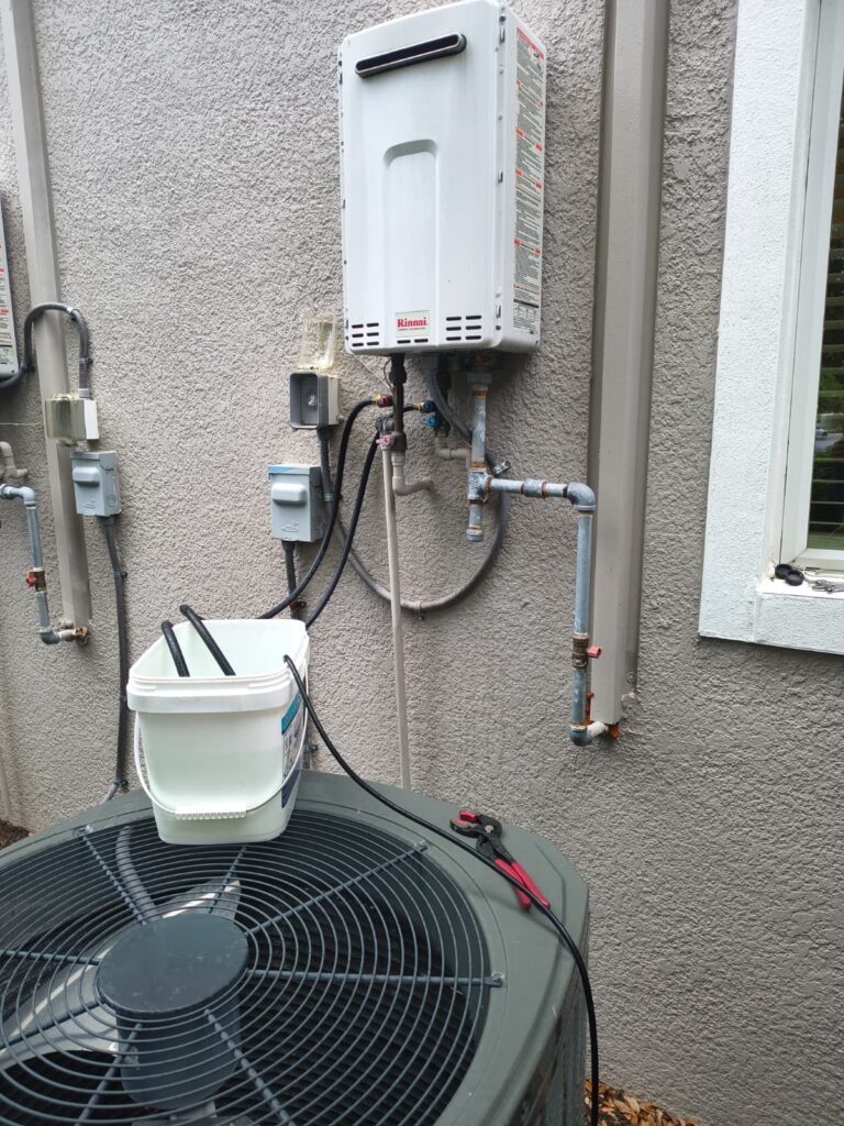 Descaling an outdoor tankless water heater with a pump and bucket in Lithia, FL 33547.