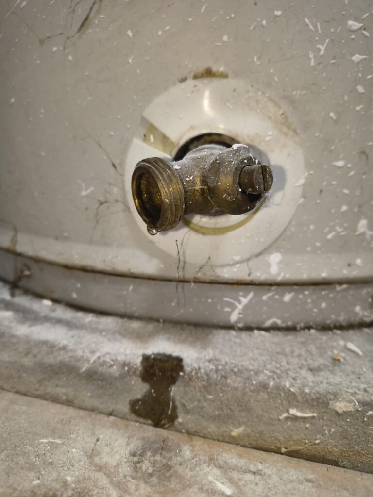 A leaking drain valve at the base of a water heater in Tampa, FL 33624.