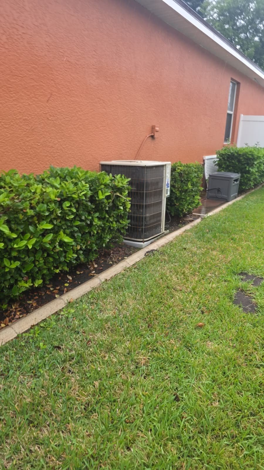 Visit #3: Outdoor view of AC unit beside house with landscaping in Riverview, FL 11705.